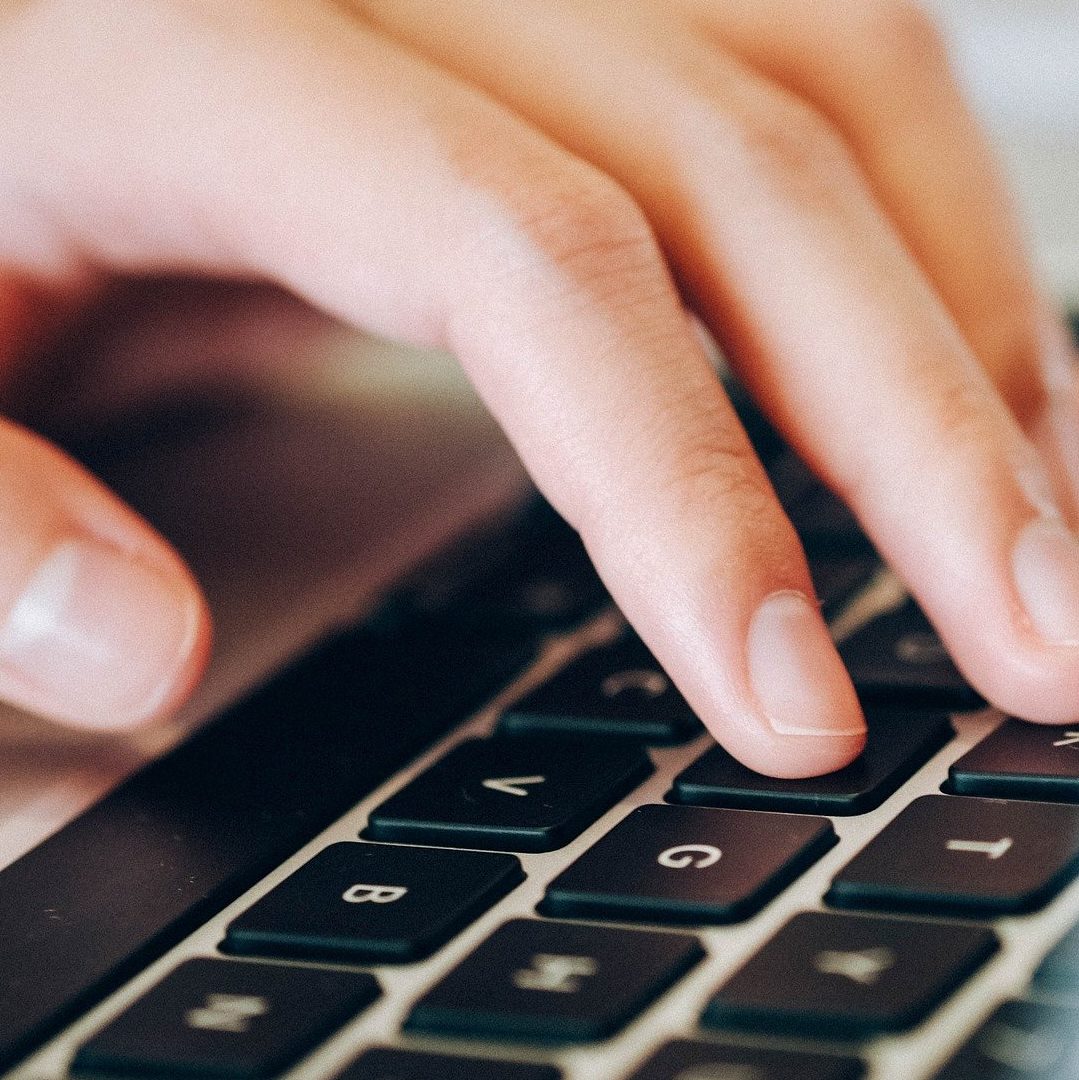 fingers hovering over a key board